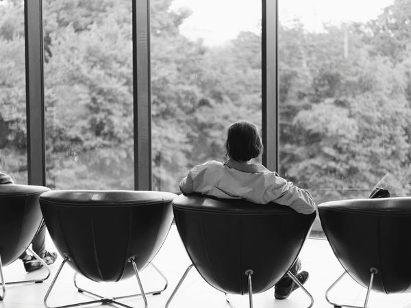 A calm and modern office space with a person stretching nearby.